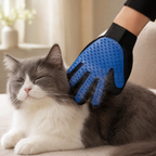 Blue Furvelis grooming glove gently collecting loose fur from a relaxed grey and white cat